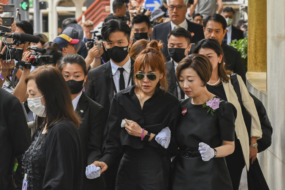 Relatives leave after a funeral for Coco Lee in Hong Kong, Tuesday, Aug. 1, 2023. Lee was being mourned by family and friends at a private ceremony Tuesday a day after fans paid their respects at a public memorial for the Hong Kong-born entertainer who had international success. (AP Photo/Billy H.C. Kwok)