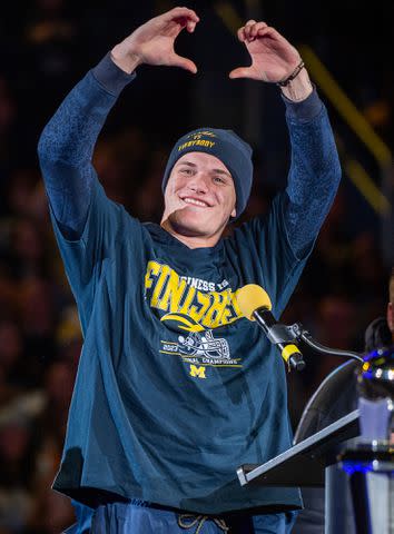 <p>Aaron J. Thornton/Getty</p> J.J. McCarthy onstage during the National Championship Celebration at Crisler Center on January 13, 2024 in Ann Arbor, Michigan.