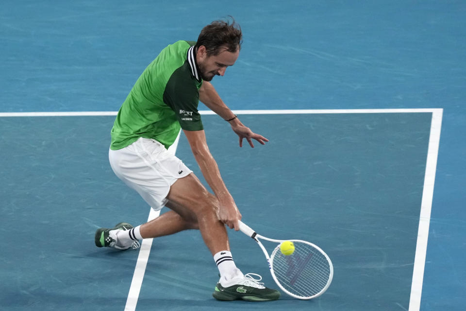 Daniil Medvedev of Russia plays a backhand return to Jannik Sinner of Italy during the men's singles final at the Australian Open tennis championships at Melbourne Park, in Melbourne, Australia, Sunday, Jan. 28, 2024. (AP Photo/Alessandra Tarantino)