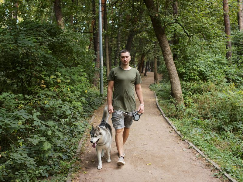 Belarusian software engineer Max Korolevsky walks with his dog in Kyiv