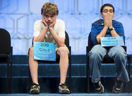 Cole Shafer-Ray (L) of Oklahoma City, Oklahoma, and Siddharth Krishnakumar of Houston, Texas, wait their turn to spell a word during the final round of the 88th annual Scripps National Spelling Bee at National Harbor, Maryland May 28, 2015. REUTERS/Joshua Roberts