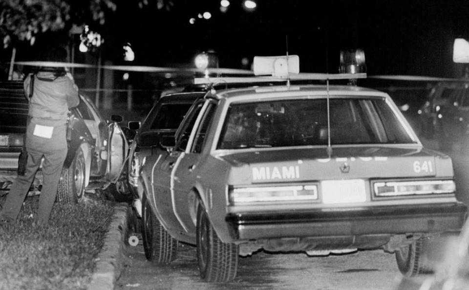 A crime scene technician works around a car that was involved in a shooting by a Miami police officer in 1985.