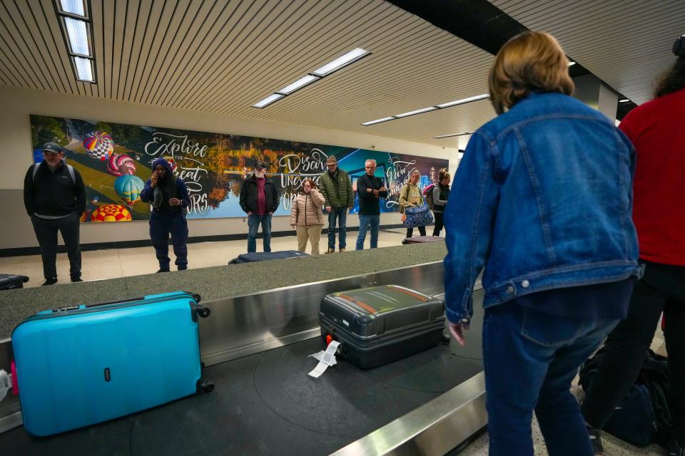 People wait for their luggage at the Des Moines International Airport on Monday, Nov. 14, 2022. (Margaret Kispert/The Des Moines Register via AP)