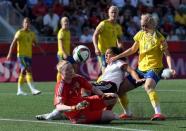 Jun 20, 2015; Ottawa, Ontario, CAN; Germany forward Celia Sasic (13) collides with Sweden goalkeeper Hedvig Lindahl (1) as defender Amanda Ilestedt (14) defends during the second half in the round of sixteen in the FIFA 2015 women's World Cup soccer tournament at Lansdowne Stadium. Mandatory Credit: Matt Kryger-USA TODAY Sports