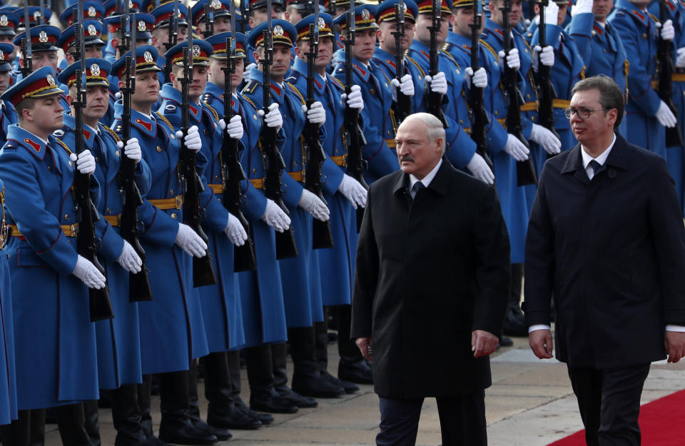 In this photo taken Tuesday, Dec. 3, 2019, Belarus President Alexander Lukashenko, centre, reviews the honor guard with Serbian President Aleksandar Vucic upon his arrival at the Serbia Palace in Belgrade, Serbia. In a surprise move Thursday Aug. 27, 2020, Serbia has joined the European Union in its rejection of the election results in Belarus that kept the country's longtime leader in power and condemned his crackdown against pro-democracy protesters. (AP Photo/Darko Vojinovic)