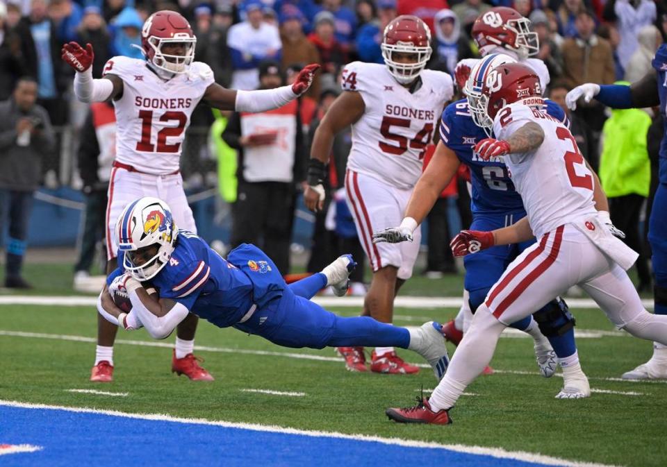 With 55 seconds left in the game, Kansas running back Devin Neal (4) dives into the end zone to score the go-ahead touchdown against Oklahoma on Saturday, Oct. 28, 2023, at David Booth Memorial Stadium in Lawrence, Kansas. The Jayhawks defeated the Sooners 38-33.