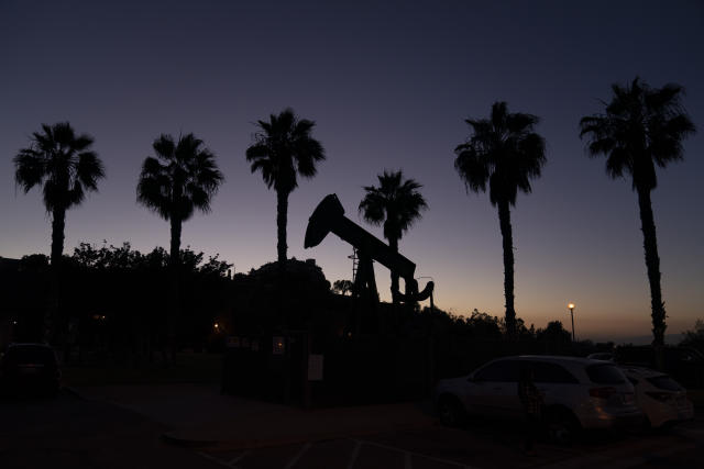 FILE - A pump jack sits idle in front of palm trees on June 9, 2021, in Signal Hill, Calif. A California legislative committee has blocked a bill that would have made oil companies liable for the health problems of people who live close to oil wells. It's among dozens of bills that did not survive the legislature's suspense file hearings. (AP Photo/Jae C. Hong, File)