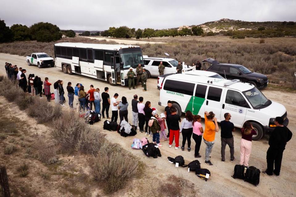 Migrants are processed by US Customs and Border Protection officers after they cross the Mexican border. James Keivom