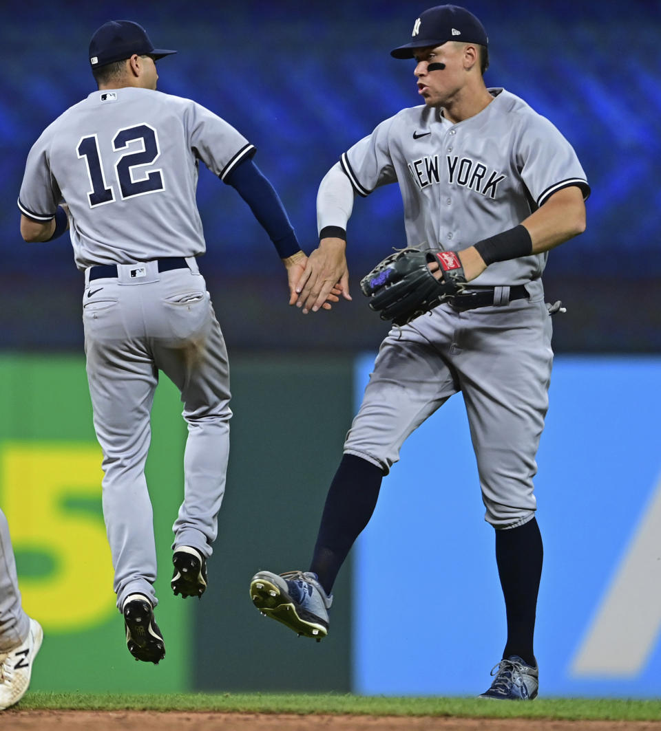 New York Yankees center fielder Aaron Judge, right, and shortstop Marwin Gonzalez celebrate after the Yankees defeated the Cleveland Guardians 6-1 in the second baseball game of a doubleheader Saturday, July 2, 2022, in Cleveland. (AP Photo/David Dermer)