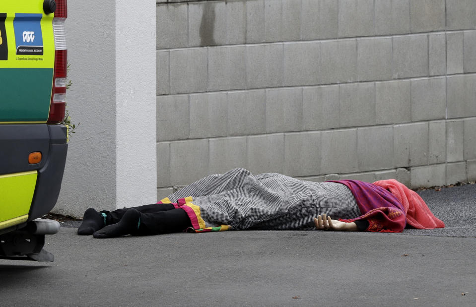 A body lies on the footpath outside a mosque in central Christchurch, New Zealand, Friday, March 15, 2019, following a mass shooting. (AP Photo/Mark Baker)