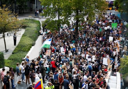 People gather at Seattle City Hall during a Climate Strike march in Seattle