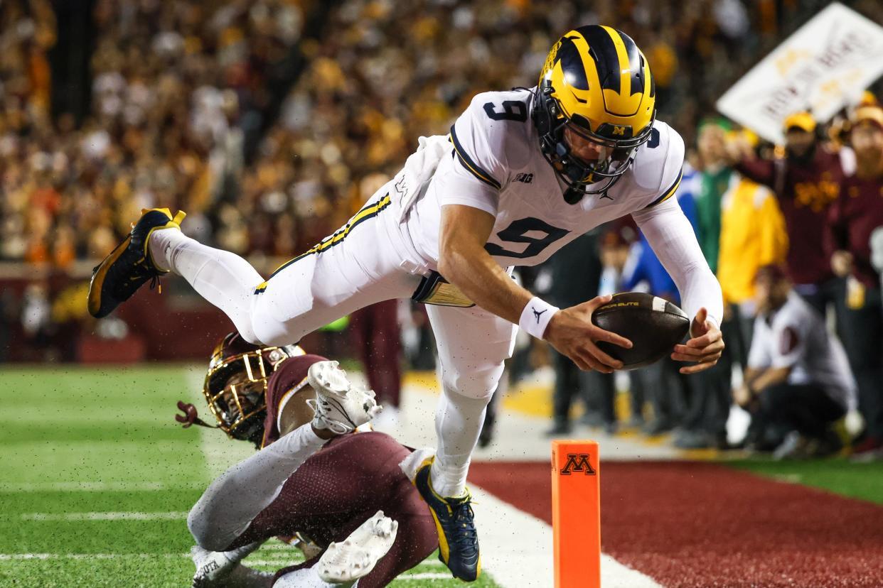 Michigan Wolverines quarterback J.J. McCarthy (9) dives for a touchdown against the Minnesota Golden Gophers during the second quarter at Huntington Bank Stadium.