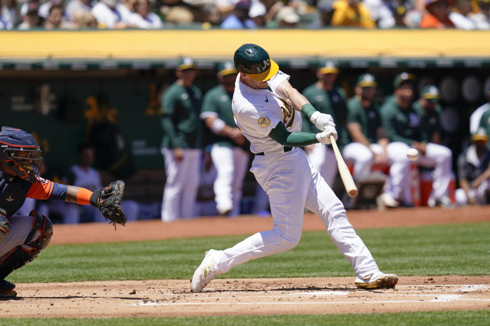 Oakland Athletics' Sean Murphy, right, hits a double against the Houston Astros during the first inning of a baseball game in Oakland, Calif., Saturday, July 9, 2022. (AP Photo/Godofredo A. Vásquez)