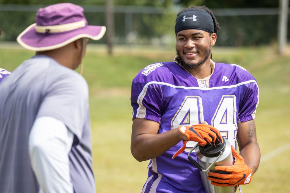 Defensive lineman Selah Brown talks with coaches between drills during a Louisville Male football practice Wednesday afternoon. Aug. 4, 2021