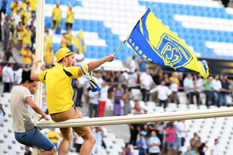 Clermont's supporters climb goal posts after Clermont defeated Racing 92, 37-31 at the French Top 14 rugby union semi-final match on May 27, 2017 in Marseille France