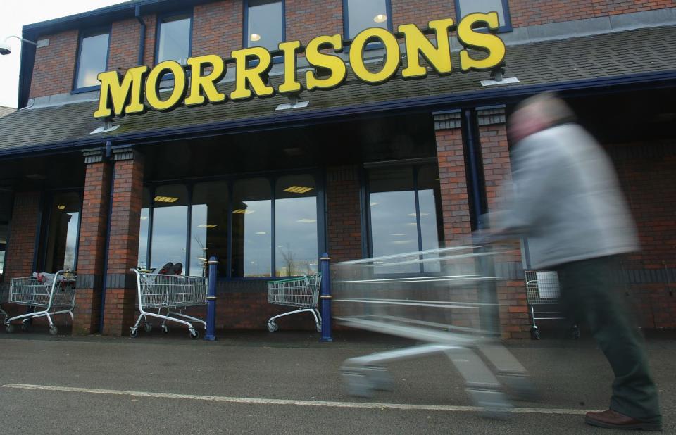 A shopper pushes his cart outside a Morrisons supermarket (Getty Images)