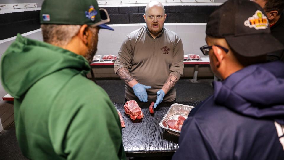 Product Coach David Esch, 43, of Clinton Twp goes over why certain cuts of meat that were disqualified with each meatcutter after the first round of the Texas Roadhouse Qualifier meat cutting challenge at Big Boy Arena in Fraser, Mich. on Tuesday, Sept. 19, 2023.