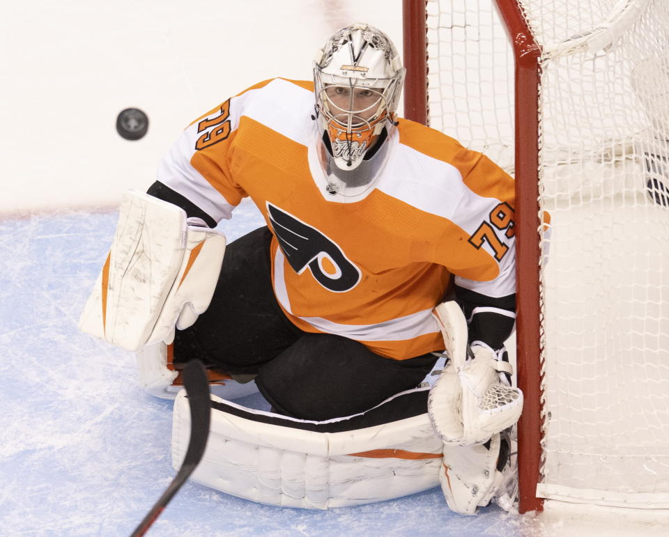 A stickless Philadelphia Flyers goaltender Carter Hart (79) watches the puck during the first period of NHL hockey Eastern Conference Stanley Cup first-round playoff action against the Montreal Canadiens in Toronto, Friday, Aug. 14, 2020. (Frank Gunn/The Canadian Press via AP)