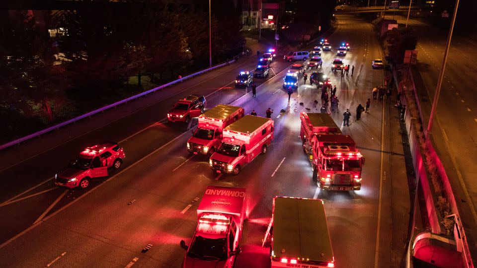 Emergency personnel working at the site where a driver sped through a protest-related closure on the Interstate 5 freeway in Seattle, authorities said early Saturday, July 4, 2020. - James Anderson via AP
