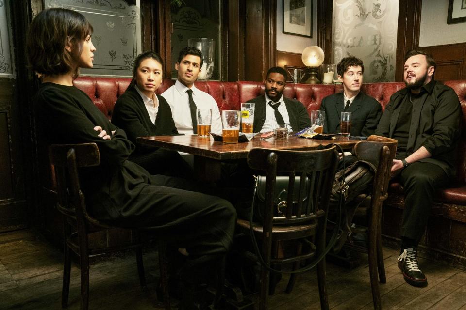 Five characters in 3 Body Problem sitting at a table drinking