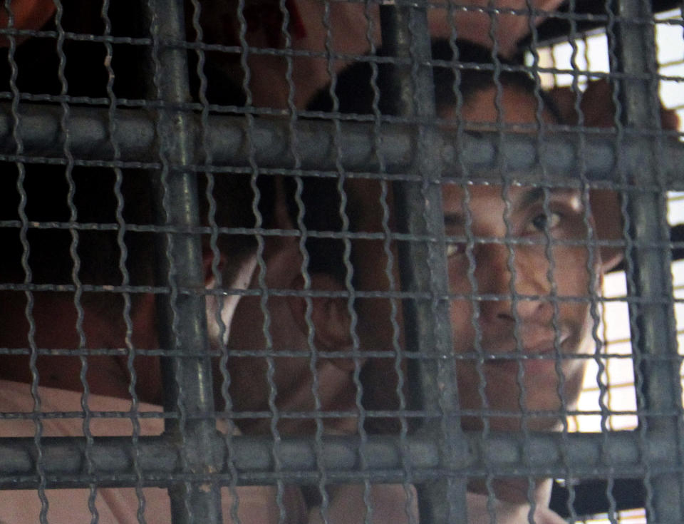 Surasak Suwannachote, right, is transported with other prisoners on a prison van out of Phuket criminal court in Phuket, southern Thailand Wednesday, Aug. 8, 2012. Surasak, 26, and another Thai suspected Surin Tabthong were sentenced to life in prison Wednesday for murdering a 60-year old Australian tourist woman they were trying to rob on one of Thailand's most popular resort islands. (AP Photo)