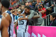 Carmelo Anthony #15 of the USA Mens Senior National team hugs The First Lady Michelle Obama after defeating France 98-71 at the Olympic Park Basketball Arena during the London Olympic Games on July 29, 2012 in London, England. NOTE TO USER: User expressly acknowledges and agrees that, by downloading and/or using this Photograph, user is consenting to the terms and conditions of the Getty Images License Agreement. Mandatory Copyright Notice: Copyright 2012 NBAE (Photo by Jesse D. Garrabrant/NBAE via Getty Images)