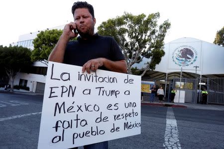 Raul Murillo attends a rally in front of the Mexican Consulate to protest Donald Trump's visit to Mexico in Los Angeles, California. REUTERS/Jonathan Alcorn