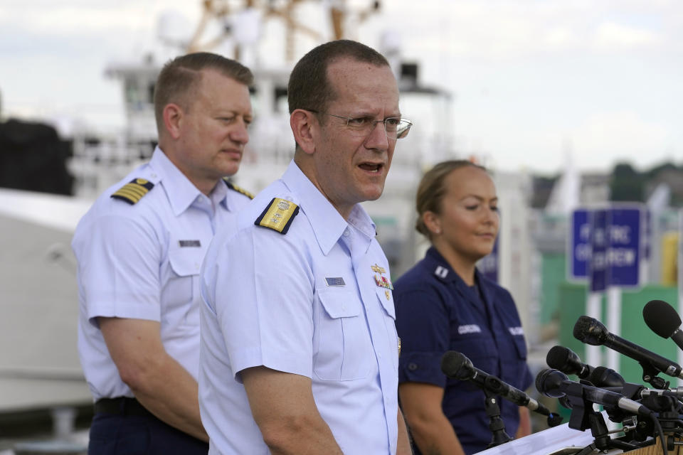 U.S. Coast Guard Rear Adm. John Mauger, commander of the First Coast Guard District, center, speaks to members of the media as Capt. Jason Neubauer, chief investigator, U.S. Coast, left, and Samantha Corcoran, public affairs officer of the First Coast Guard District, right, look on during a news conference, Sunday, June 25, 2023, at Coast Guard Base Boston, in Boston. The U.S. Coast Guard said it is leading an investigation into the loss of the Titan submersible that was carrying five people to the Titanic, to determine what caused it to implode. (AP Photo/Steven Senne)
