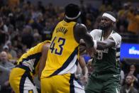 Milwaukee Bucks' Bobby Portis (9) and Indiana Pacers' Andrew Nembhard, left, get into an altercation during the first half of Game 4 of the first round NBA playoff basketball series, Sunday, April 28, 2024, in Indianapolis. (AP Photo/Michael Conroy)