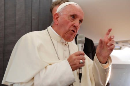 Pope Francis speaks with the media onboard a plane during his flight back from Tallinn after the final leg of his visit to the Baltic states, Estonia September 25, 2018. REUTERS/Max Rossi