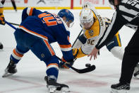 New York Islanders' Jean-Gabriel Pageau (44) and Nashville Predators' Tommy Novak (82) face off during the first period of an NHL hockey game in Elmont, N.Y., Saturday, April 6, 2024. (AP Photo/Peter K. Afriyie)