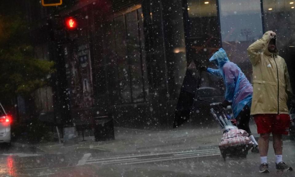 Umbrella is blown inside out as a person crosses the street during a storm in Washington DC.