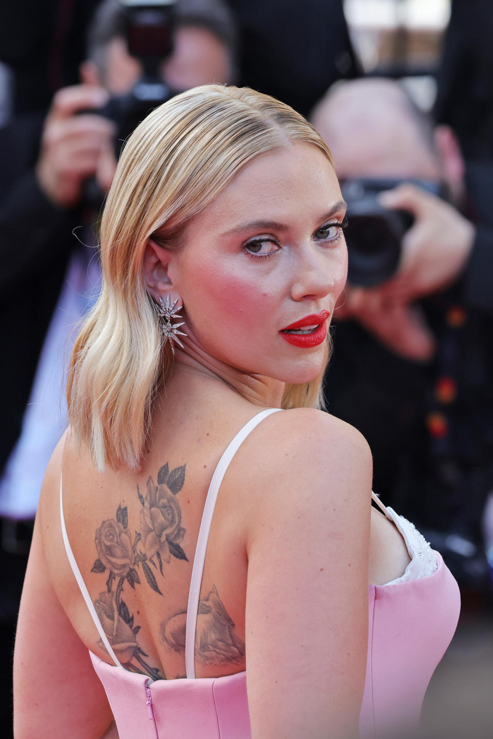 A closeup of Scarlett Johansson looking over her shoulder on the red carpet