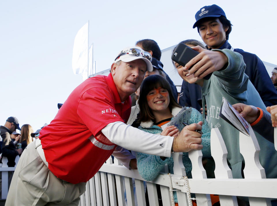 Woody Austin, left, has a photo taken with young fans after finishing his round during the final day of the Dominion Energy Charity Classic golf tournament at The Country Club of Virginia in Richmond, Va., Sunday, Oct. 21, 2018. (Daniel Sangjib/Richmond Times-Dispatch via AP)