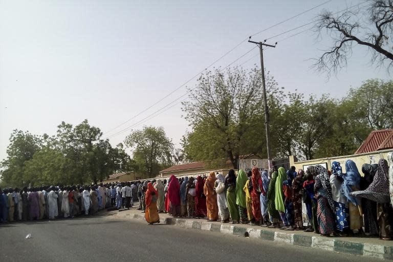 Internally Displaced People who fled areas affected by Boko Haram violence, queue at a polling station in Maiduguri on March 28, 2015