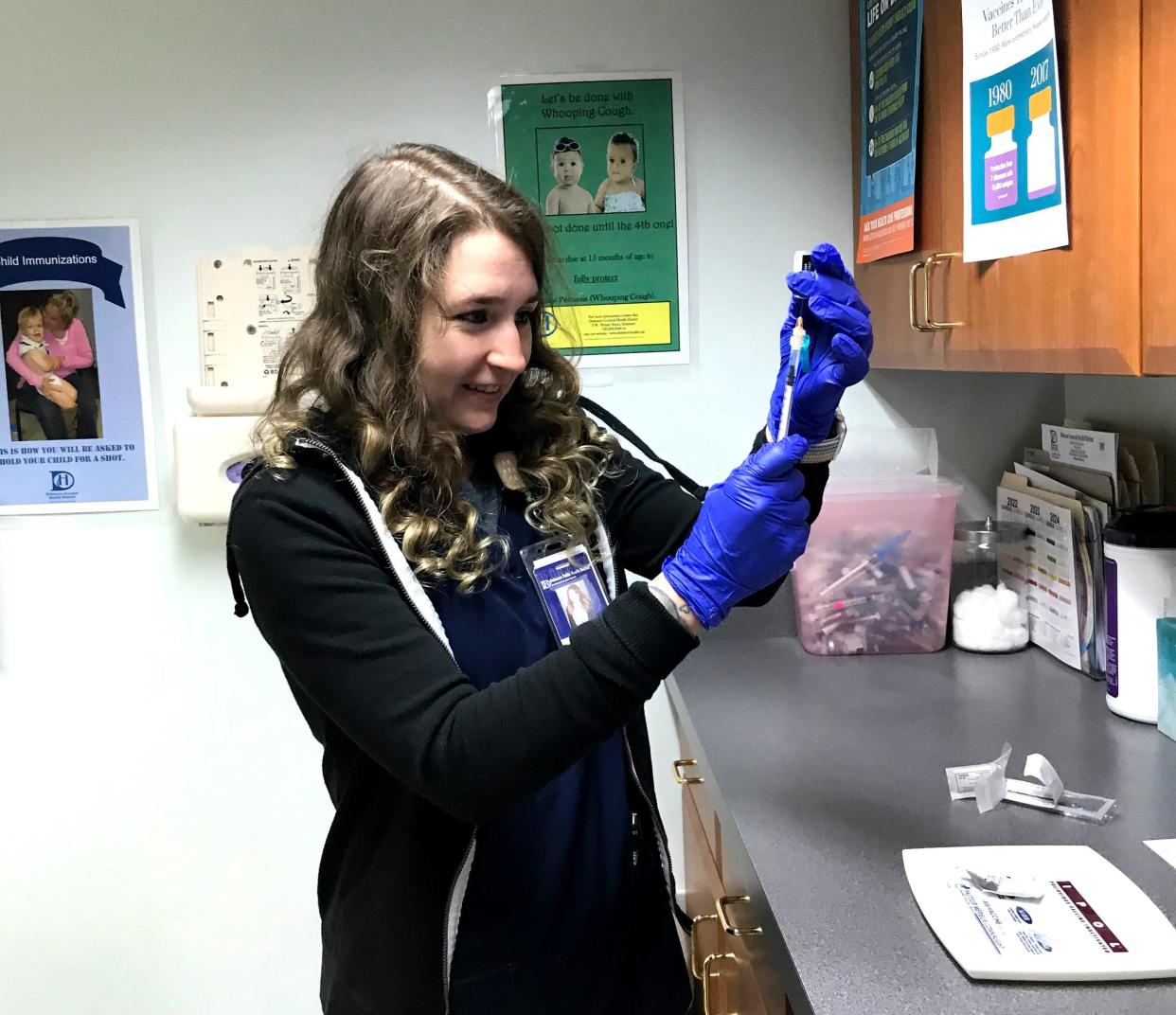 Cori Spring, a registered nurse with the Delaware Public Health District, prepares an injection during one of the district's regular clinics. The clinic schedule is posted at delawarehealth.org.