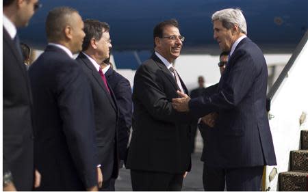 U.S. Secretary of State John Kerry (R) is greeted by Egypt's Ambassador Farid Munib (2nd R), Chief of Protocol, in Cairo November 3, 2013. REUTERS/Jason Reed