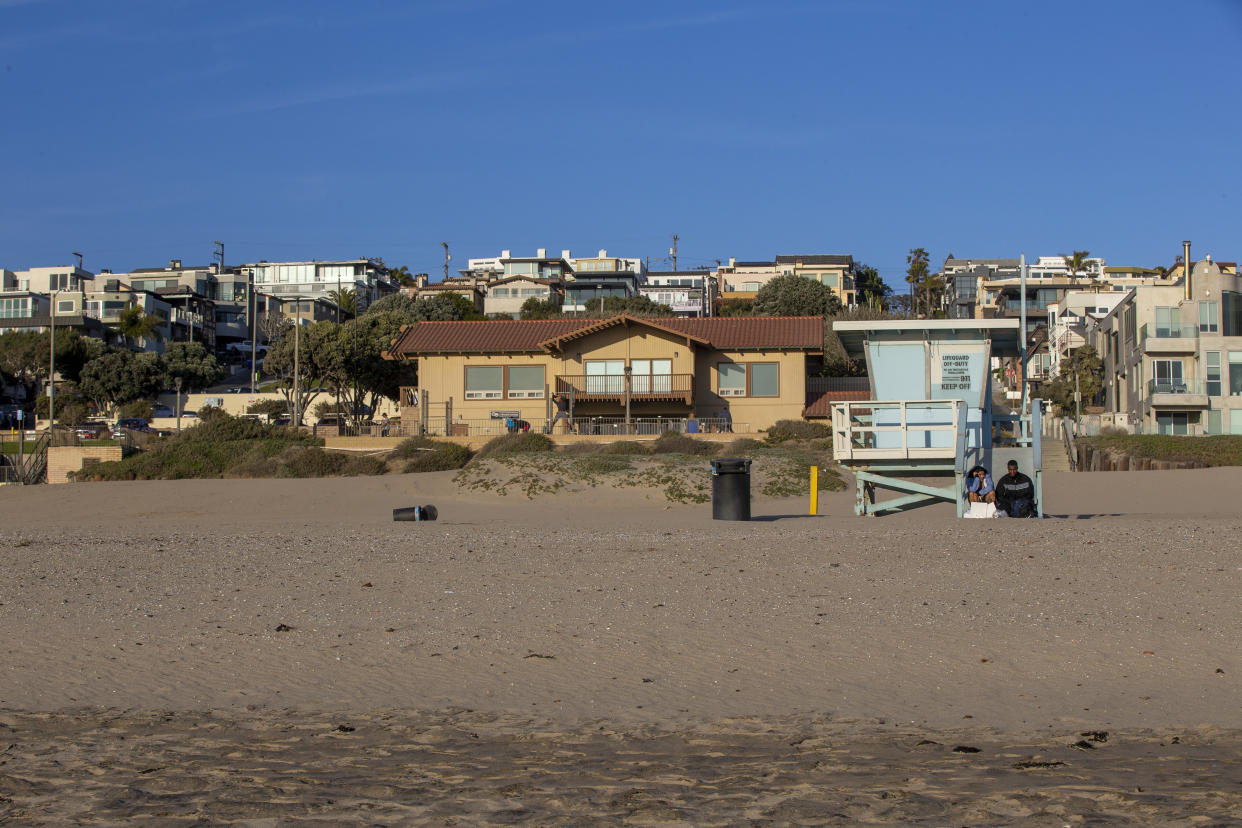 A couple sit on the lifeguard tower between 26th and 27th Streets at Bruce's Beach, which is part of the Bruce property.