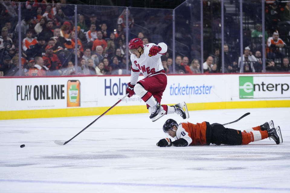 Carolina Hurricanes' Teuvo Teravainen, top, leaps over Philadelphia Flyers' Cam York during the third period of an NHL hockey game, Monday, Oct. 30, 2023, in Philadelphia. (AP Photo/Matt Slocum)
