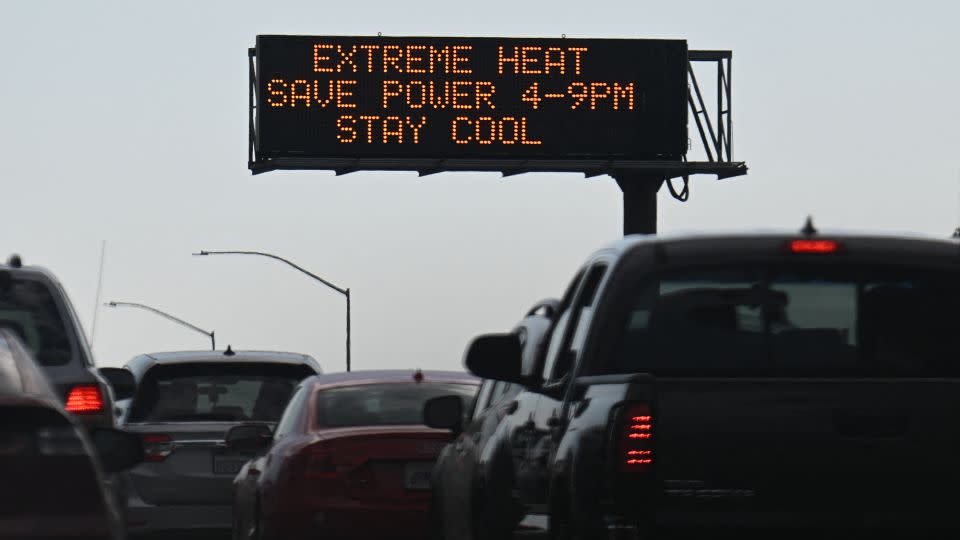 Vehicles drive past a heat warning in Los Angeles on September 2, 2022. - Patrick T. Fallon/AFP/Getty Images
