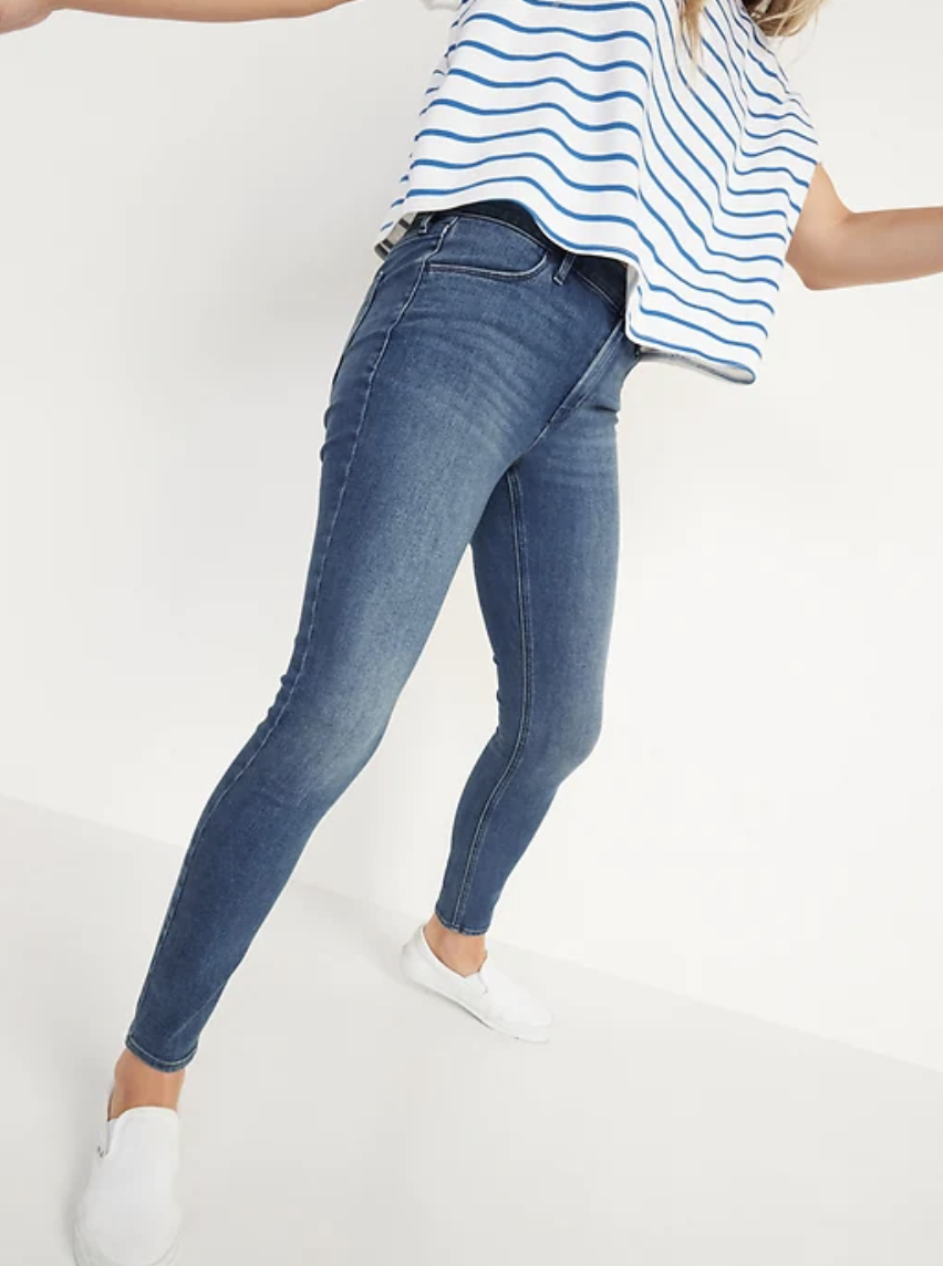 woman in blue Mid-Rise Medium-Wash Super Skinny Jeans and white and blue striped t-shirt