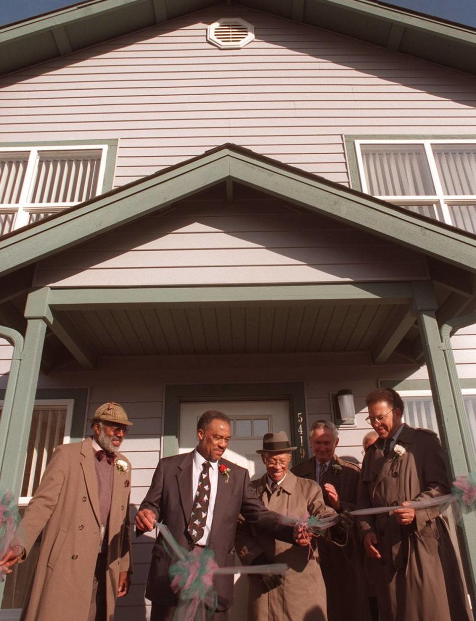 The official ribbon-cutting of ‘Dixon Village’: (left to right) Emmette Bryant, Thomas Dixon, Rev. Brazil, Wayne Morris (behind) and Hugh Price. Photo taken Sept. 14, 1995