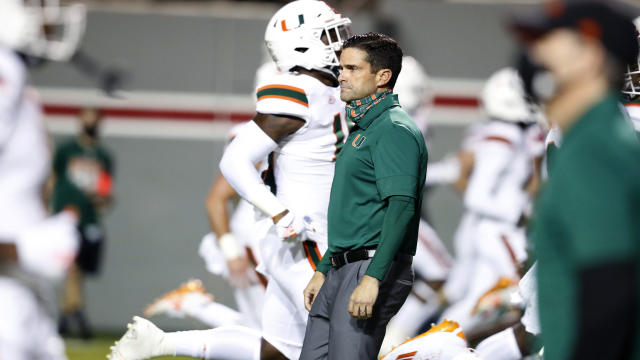 Miami coach Manny Diaz watches his players warm up for an NCAA college football game against North Carolina State on Friday, Nov. 6, 2020, in Raleigh, N.C. (Ethan Hyman/The News &amp; Observer via AP, Pool)