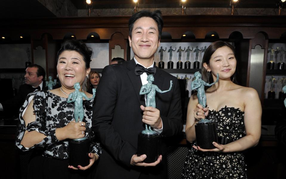 Lee Sun-kyun, with his Parasite co-stars Jeong-eun Lee (left) and Park So-dam (right)