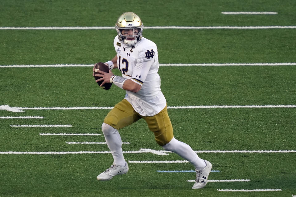 Notre Dame quarterback Ian Book (12) scrambles against North Carolina during the first half of an NCAA college football game in Chapel Hill, N.C., Friday, Nov. 27, 2020. (AP Photo/Gerry Broome)