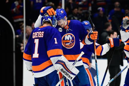 Mar 11, 2019; Uniondale, NY, USA; New York Islanders defenseman Scott Mayfield (24) reacts with goalie Thomas Greiss (1) after winning 2-0 against the Columbus Blue Jackets at Nassau Veterans Memorial Coliseum. Mandatory Credit: Catalina Fragoso-USA TODAY Sports