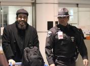 Canadian Greenpeace activist Alexandre Paul (L) smiles as he arrives at the airport in Montreal, December 27, 2013. Paul was detained by Russia for more than three months following a protest against Arctic oil drilling in international waters. REUTERS/Christinne Muschi (CANADA - Tags: ENVIRONMENT CIVIL UNREST CRIME LAW)