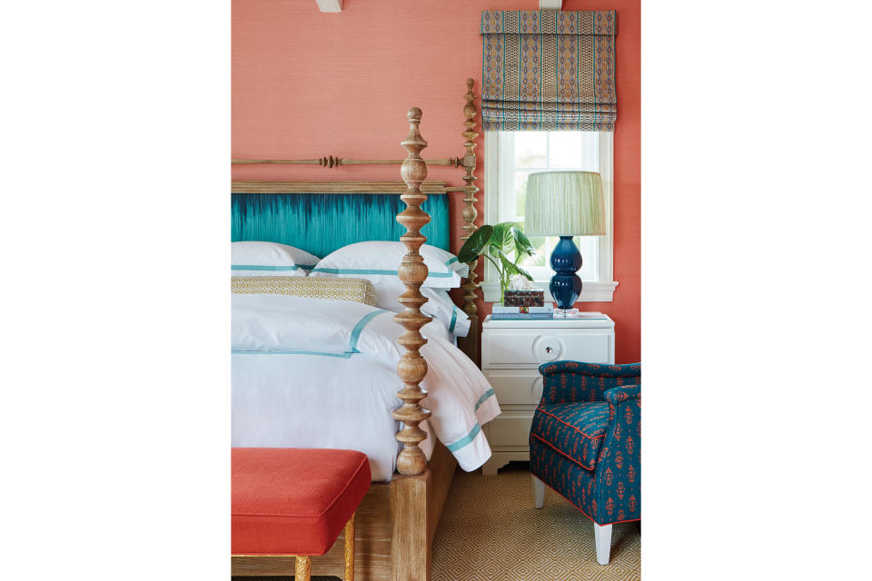 <p>“I wanted each of the guest rooms to have a playful, get-away-from-it-all vibe,” notes Sharpe, who used fanciful shades of coral to draw guests into full escape mode. The pickled cypress bed by Century is upholstered in a sea-blue ombré fabric that “has a watery effect—to me, it’s almost like a snapshot of the ocean,” says the designer. The armchair is upholstered in a peacock linen by <a href="http://www.lisafinetextiles.com/Lisa_Fine_Textiles/Index.html" rel="nofollow noopener" target="_blank" data-ylk="slk:Lisa Fine Textiles;elm:context_link;itc:0;sec:content-canvas" class="link ">Lisa Fine Textiles</a>.</p>