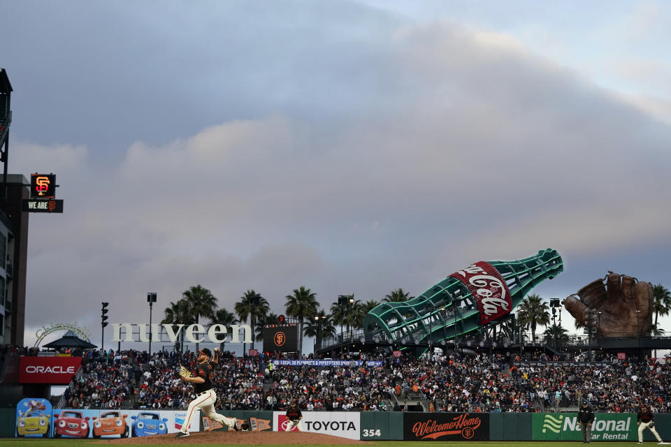 San Francisco Giants' Zack Littell, bottom left, pitches against the Atlanta Braves during the fourth inning of a baseball game in San Francisco, Saturday, Sept. 18, 2021. (AP Photo/Jeff Chiu)