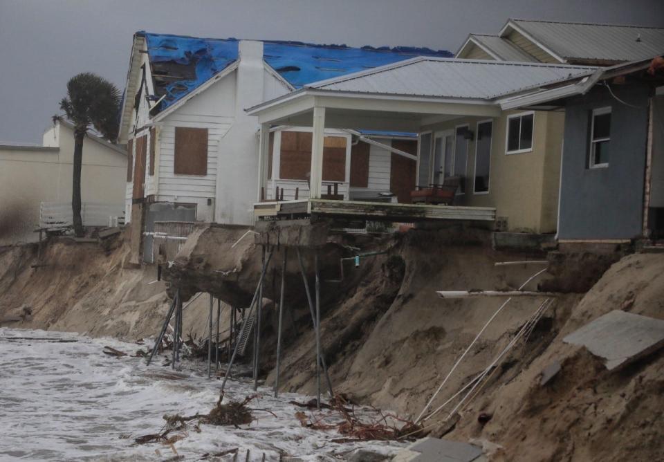 Homes in Wilbur-by-the-Sea are dangerously close to falling into the ocean Thursday, Nov. 10, 2022, as Tropical Storm Nicole batters Florida's east coast.